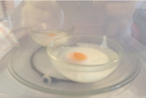 Eggs poaching in a microwave oven.  